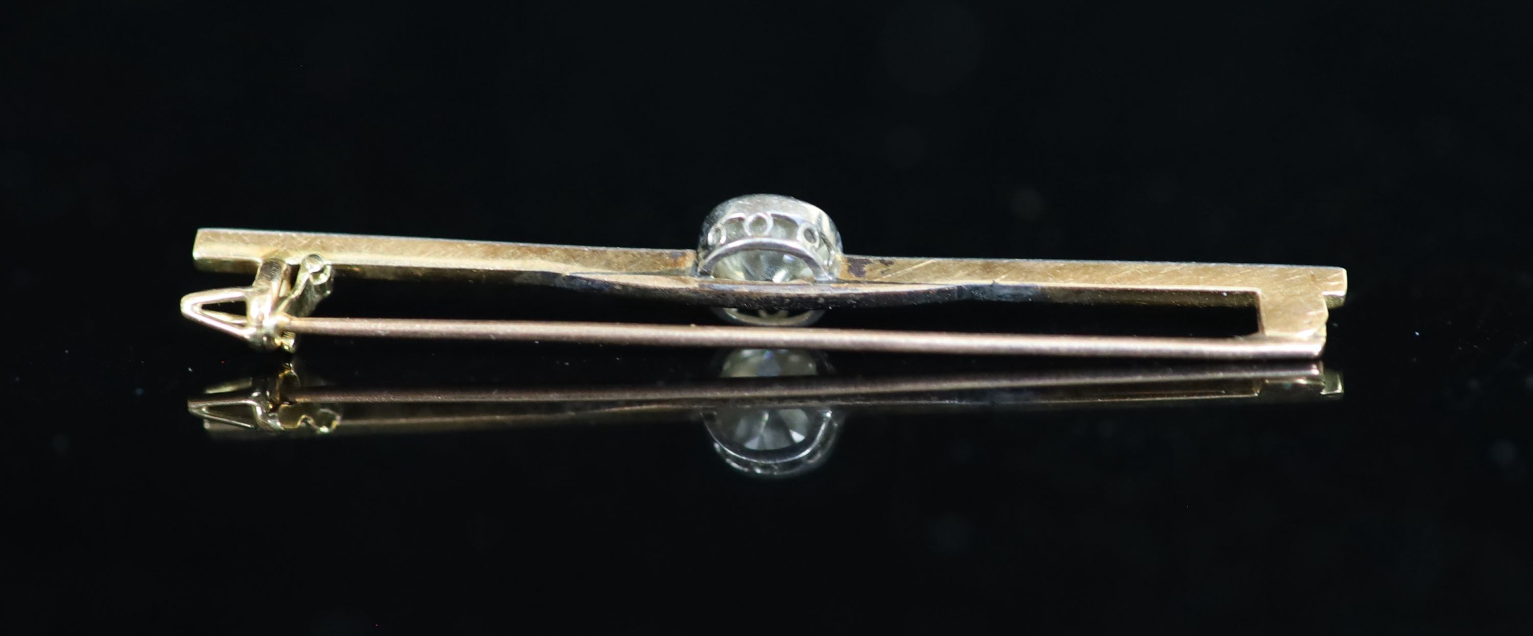 An early 20th century gold, platinum and solitaire diamond set bar brooch